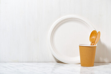 eco-friendly disposable tableware made from recycled materials on white background