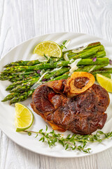 braised osso buco with grilled asparagus, top view