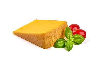 Semi-hard cheese with saffron and red cherry tomatoe and green basil leaves, close-up, isolated on white background.