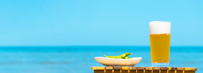 A glass of beer to drink on the beach. And Edamame. ...