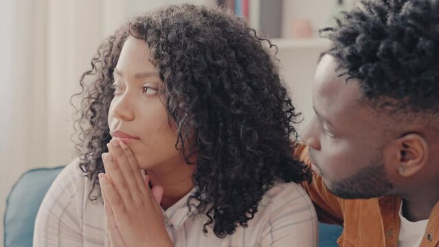 African American man trying to comfort upset wife, problems in a relationship