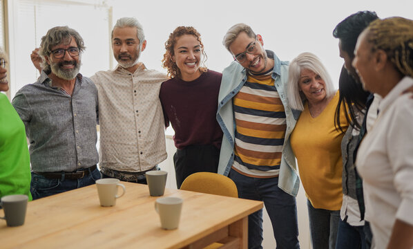 Multi Generational People Having Fun Inside Kitchen At Home While Hugging Each Other - Multiethnic Friends Enjoy Day Together Indoor