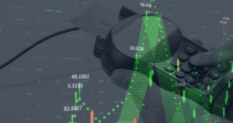 Image of graphs and financial data over hand of caucasian man holding payment terminal