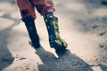 The boy child got his boot into the mud, failures and childhood accidents, dirty boots and calm...