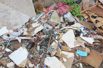 A pile of trash on the street without a bin