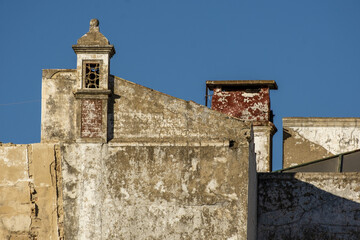 Fototapeta na wymiar Traditional Portuguese chimney on top of a old ruined building in Faro, Algarve, Portugal