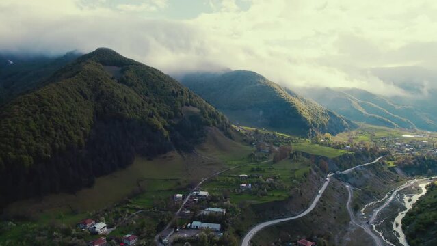 aerial view of cloudy Caucasus mountains and Georgian Military Highway, Kazbegi, Georgia. High quality 4k footage