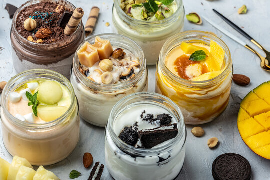 Large collection of Ice cream, delicious gelati with fresh pistachio, chocolate, caramel, melon, mango, chocolate chip sandwich cookies with aromatic vanilla pod on white