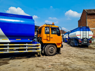 Fuel tanker truck or cooking oil transport truck and liquid fuel tanker truck line up on the road