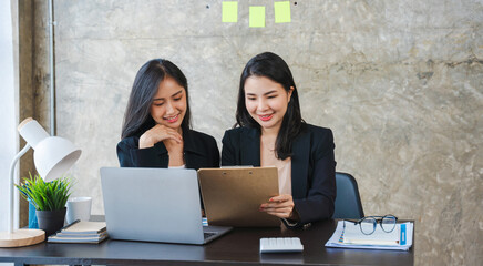 Happiness two women colleague working together team meeting in office desk. Team business partners working with computer laptop startup company.