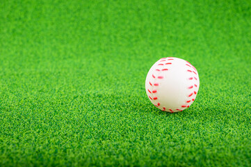 Baseball or softball put on the green grass