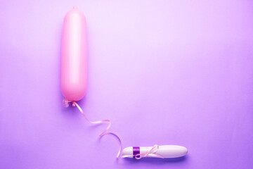 female dildo for sex and masturbation hanging as a balloon with a phallic shape that simulates a condom on a purple background shot horizontally