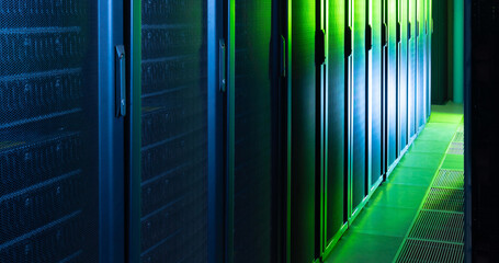 Image of empty corridor with row of blue and green computer servers