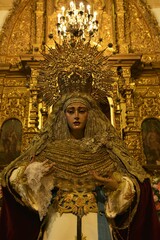 Beautiful life-size sculpture of the Virgin Mary in dramatic posture, adorned with rich clothing and jewelry at Iglesia Jesús Nazareno church, Chiclana de la Frontera, Spain