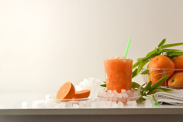 Detail of orange drink with ice on table isolated background