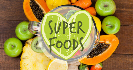 Super foods text banner against various fruits on wooden surface