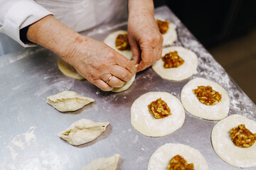 the cook with his hands works with the dough