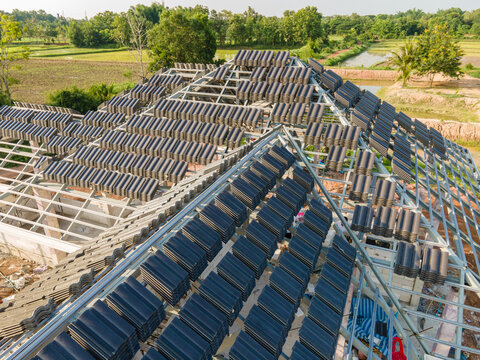 Aerial view of Concrete or CPAC cement roof tiles on the new roof structure. under construction residential building. Infrastructure of the house at the construction site.