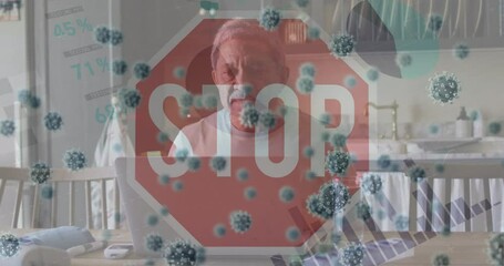 Animation of stop sign and virus cells over sad biracial man using laptop at home - Powered by Adobe