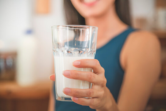 Young asian woman drinking milk from the glass, Food and healthy concept.