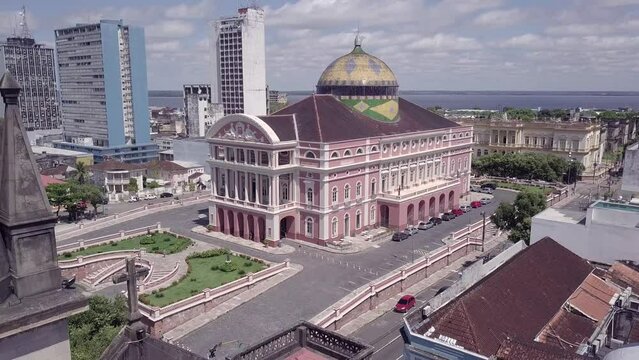 Amazonas theatre building and Manaus city center skyline with Rio Negro background in beautiful aerial drone view. Amazon, South America, Brazil. 4K. Concept of cityscape, travel, architecture. 4K
