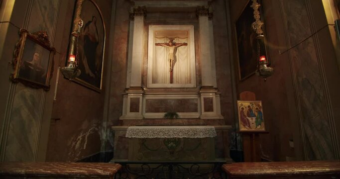 Spiritual clip. View of a wooden cross in a small chapel in the Basilica of Desio - 01