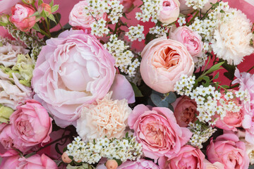 Floral backdrop, background. Red pink bouquet with roses, peony and little white flowers close-up, macro details, texture