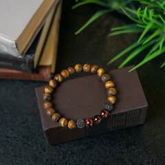 bracelet made of natural wood, among everyday things. desktop decoration
