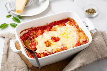 close up of baked pasta canelloni with beef cheese tomato food in white dish