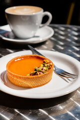 mango tart with coffee on summer terrace