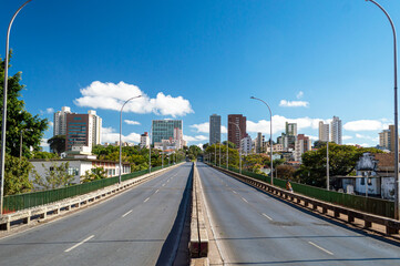 Viaduct, buildings and trees in the city of Belo Horizonte. Beautiful blue sky. Clouds.