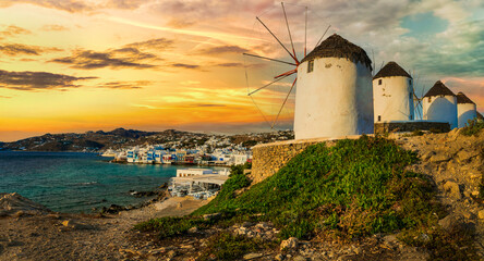 Traditional greek windmills of Mykonos island over sunset. Greece, Cyclades - obrazy, fototapety, plakaty