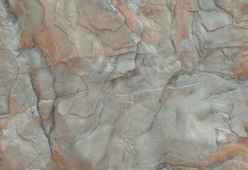 Natural stone texture close up. Large rock in grey red color palette. Abstract organic background.