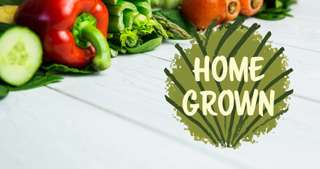 Image of home grown text in green over fresh organic vegetables on wooden boards