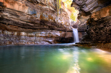 Italy, 2 June 2022. Wonderful waterfall in Premilcuore surrounded by nature with rocks, in long exposure.