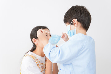 A child putting a mask on his mother.