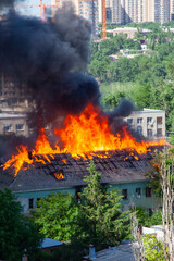 A fire in an old abandoned house, a view from the window of a neighboring high-rise building