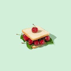 Sandwich made of red cherry berries on pastel background.  Creative heathy snack food, fruit. Summer trend shadows.  Summer aesthetic. Pop art.