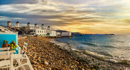Mykonos island,Cyclades. Greece summer holidays. Sunset in the bar by the sea in famous popular...