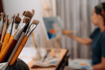 Crop artist drawing on canvas in art studio