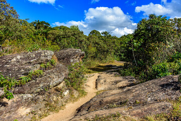 Fototapeta na wymiar Trail through the rocks and vegetation used for expeditions in the hills around the city of Lavras Novas in Minas Gerais