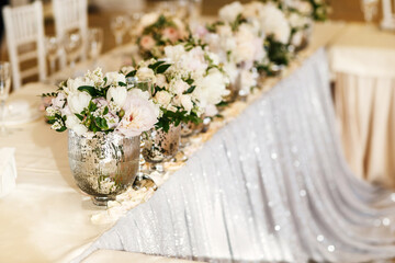 Bouquets flower in vase on the wedding table