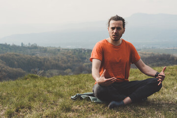 Man sitting on the mountain and telling something