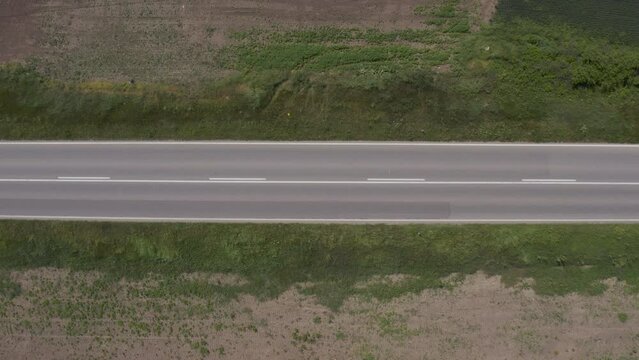 Aerial shot of old red fire truck speeding on highway, drone pov