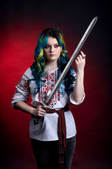Fototapeta na wymiar Ukrainian girl with a sword in vyshyvanka with viburnum in her hands on a red background. idea war in Ukraine attack Russia