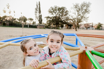 Fototapeta na wymiar Twin girls, children at the playground
