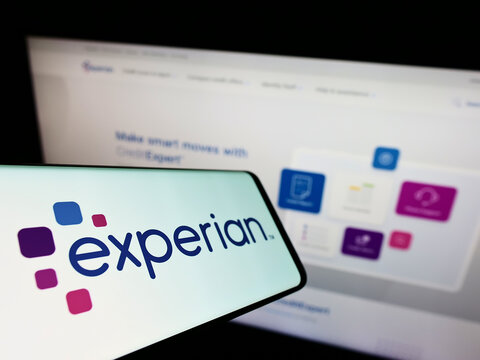 Stuttgart, Germany - 05-29-2022: Mobile phone with logo of credit reporting company Experian plc on screen in front of business website. Focus on center-left of phone display.