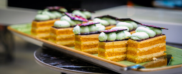 Pieces of layered honey cake on a plate close-up