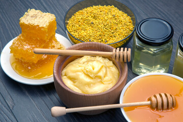 Fresh flower honey of different varieties, pollen and honeycomb with spoons on a wooden background. Organic Vitamin Health Food