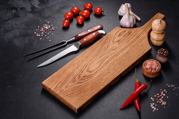 An empty plate with a knife, fork or spoon with a wooden cutting board